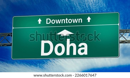 Road sign indicating direction to the city of Doha.