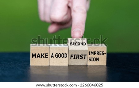 Symbol for a second chance. Hand turns wooden cube and changes the expression 'make a good first impression' to 'make a good second impression'. Royalty-Free Stock Photo #2266046025