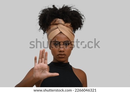 black woman makes gesture with open hand, denounces assault, moral harassment, cowardice, violence against women, isolated on gray background Royalty-Free Stock Photo #2266046321