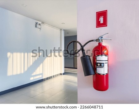 Fire extinguisher at the corner of corridor Royalty-Free Stock Photo #2266048711