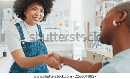 Women, envelope and smile with handshake in deal at studio or business in home. Black woman, entrepreneur or designer get letter, document or paperwork, at office in house and say thank you to client