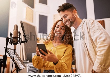 Man, woman or phone in recording studio for song lyrics, podcast ideas or album cover art in production booth. Smile, happy or musician on mobile technology for friends, singer or media collaboration Royalty-Free Stock Photo #2266048971