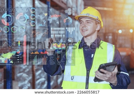 Warehouse worker using hologram visual smart information display for futuristic data business intelligent for Logistics Industry Royalty-Free Stock Photo #2266055817