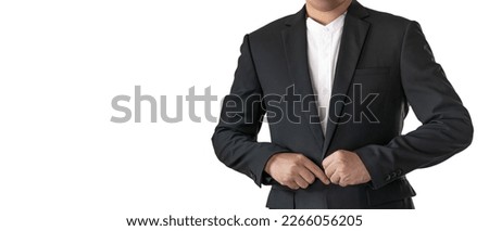 Asian man in black suit standing alone posing with arms crossed on isolated white background