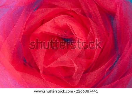 Background made of magenta tulle wraped as a flower head. Flat lay. Copy space.