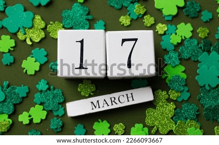 St.Patrick 's Day. March Calendar with holiday decor on green background. Flat lay. Top view.
