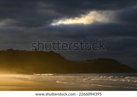 sunset on a beach with a cloudy sky with reflections