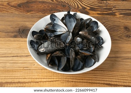 Empty Mussels Shell, Black Clams Shells, Eaten Mollusc, Empty Shellfishes, Seafood Leftovers Mussel on Wood Background Top View