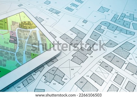 Buildings Permit concept with imaginary cadastral on digital tablet - building activity and construction industry with General Urban Plan Royalty-Free Stock Photo #2266106503