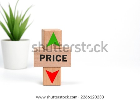 Price level symbol. A wooden cube with up and down arrow icon. Wooden block with the concept word Price on white background. Copy space. Business and price level concept.                           