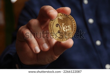 Yes or No random decision choice and gamble golden coin in hand abstract concept
