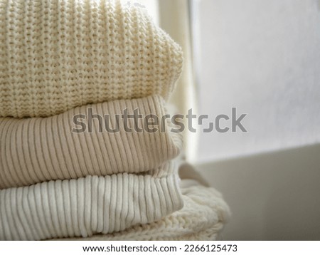 Knitted woolen clothes, after washing. close-up. Winter and autumn warm cozy sweaters for charity.