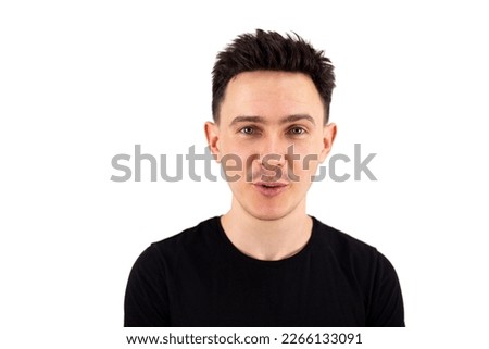 Guy talking. A handsome guy with black hair and a black T-shirt on a white background. Large portrait. isolated
