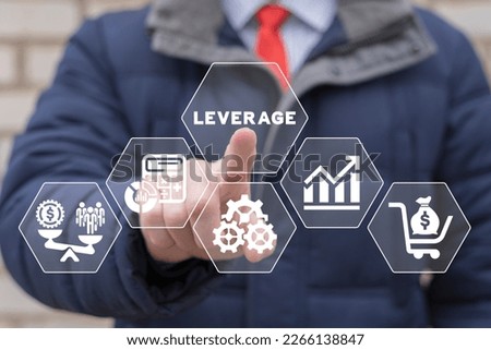 Businessman using virtual touchscreen presses word: LEVERAGE. Leverage in dollars. Leverage investing. Investor borrow money or stock to increase potential return concept. Royalty-Free Stock Photo #2266138847