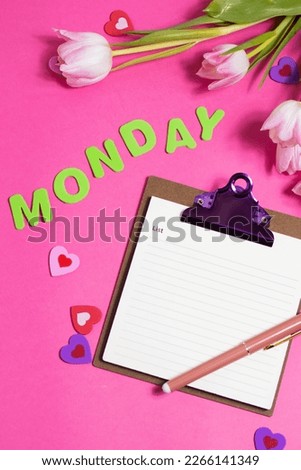 Composition with blank notebook, word Monday and beautiful tulip flowers on pink background