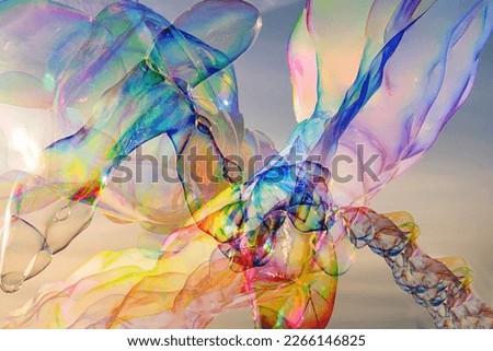 Sunlight refracting through Large colorful bubbles on the ocean coast during sunset. Royalty-Free Stock Photo #2266146825