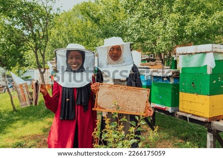 Arab investors checking the quality of honey on a large honey farm in which they invested their money. The concept of investing in small businesses