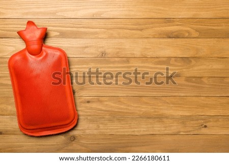 Rubber water warmer bag on wooden background