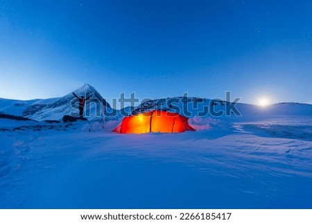 Tent with person at full moon in the snow, Kungsleden or king's trail, Province of Lapland, Sweden, Scandinavia