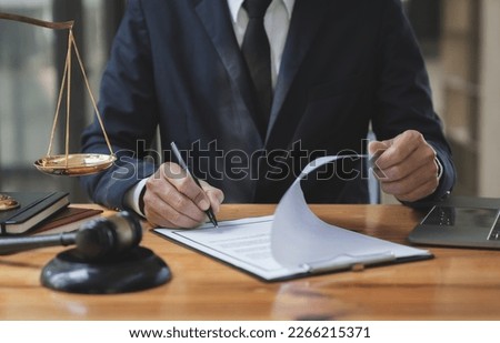 Young Asian legal advisor or lawyer reviewing business contracts or life insurance contracts for future benefits or businessman signing documents and getting a loan to start a new business.