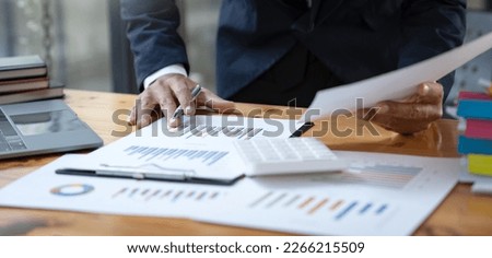 Asian businessman working in the office I'm dealing with the datasheet. financial performance trading contracts management concept management. Royalty-Free Stock Photo #2266215509