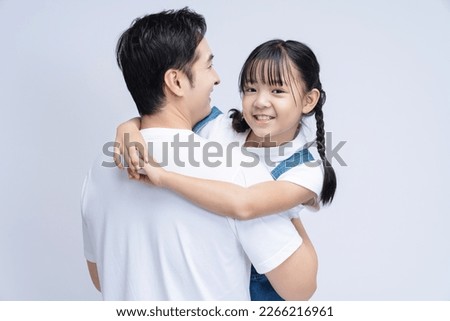 Image of Asian father and daughter on background