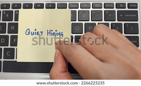 A person pointing at a note with  words Quiet Hiring written on  Royalty-Free Stock Photo #2266225235