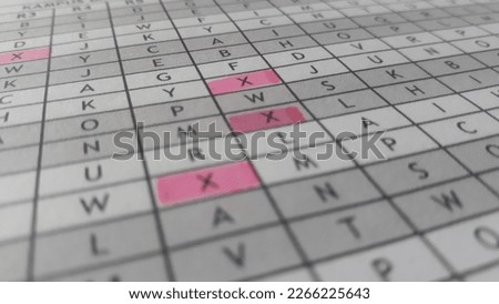 table data in the form of letter codes with a red mark on the letter X, on white paper