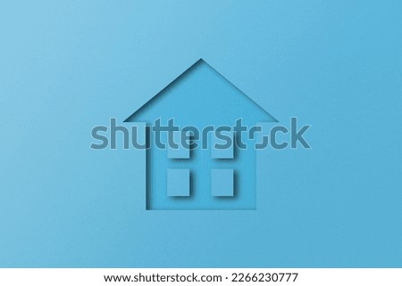 light blue paper cut out house shape isolated on light blue paper background