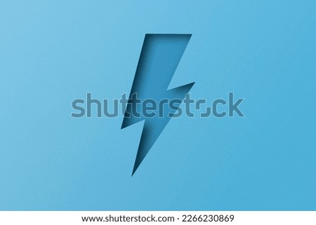 light blue paper cut into holes Lightning bolts are overlaid with light and shadow.