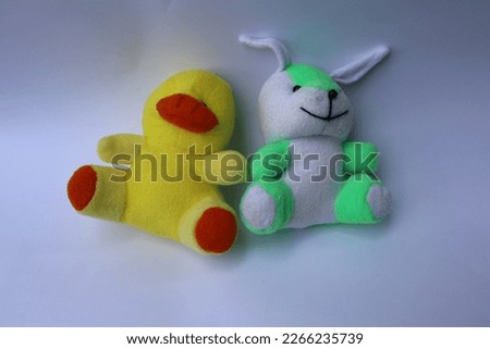 toys for children's games on a white background.yellow duck and rabbit