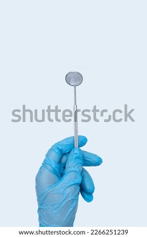 Dentist Professional tools medical equipment dentist mirror on Blue background. Dental Hygiene and Health conceptual image