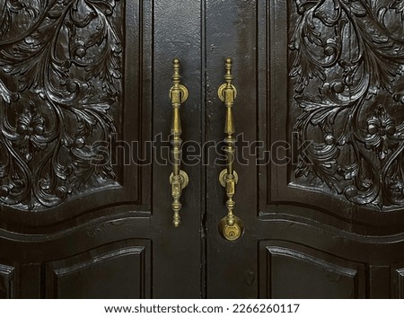 Dark double doors with golden handles. Royalty-Free Stock Photo #2266260117