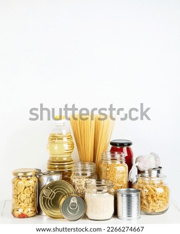 Food supplies. Crisis food stock. Different glass jars with grains, pasta, oil, nut, canned food, copy space