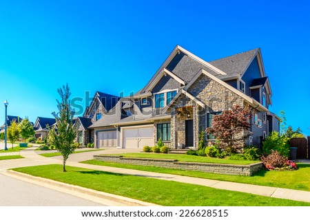 A perfect neighborhood. Houses in suburb at Spring in the north America. Royalty-Free Stock Photo #226628515