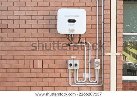 Solar inverter and isolating switches on a brick wall Royalty-Free Stock Photo #2266289137