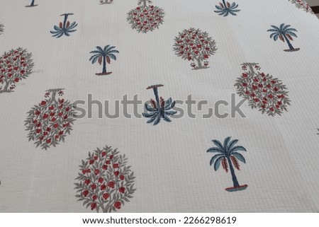 white bedspreads with graphic design spread on a bed