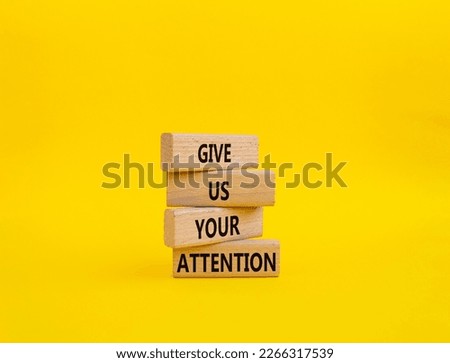 Attention symbol. Concept word Give us your attention on wooden blocks. Beautiful yellow background. Business and Give us your attention concept. Copy space