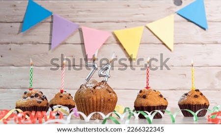 Festive birthday cakes with candles. Birthday background with numbers  74. Anniversary cards on a wooden background.