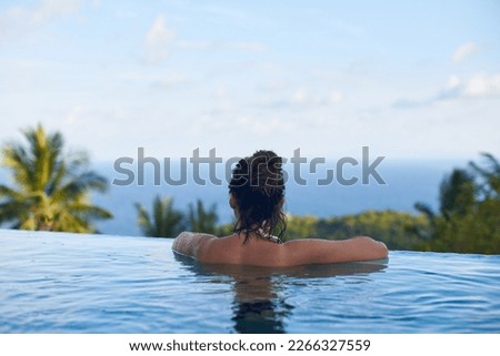 Woman relaxing in swimming pool in vacation. Woman relaxing in swimming pool in vacation on tropical island in Thailand.