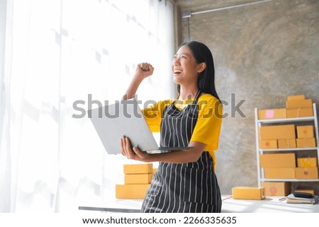 Young pretty asian start up business woman in apron working with online parcel box warehouse selling online product with social media influencer people with subscriber and followers Royalty-Free Stock Photo #2266335635