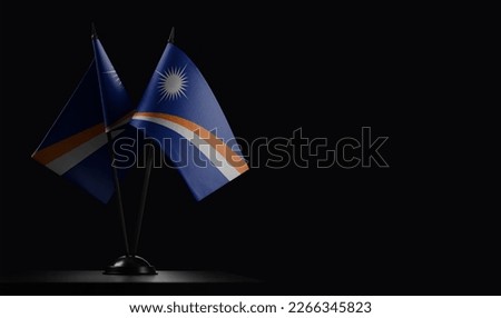 Small national flags of the Marshall on a black background.