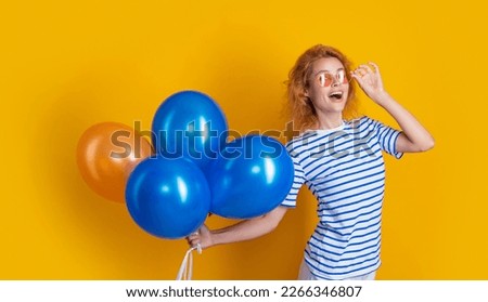 party girl with balloon in sunglasses. happy girl hold anniversary balloons in studio.