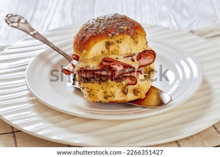Ham and Cheese Slider with Hawaiian Roll on white plate on white wood table, horizontal view from above, close-up Royalty-Free Stock Photo #2266351427