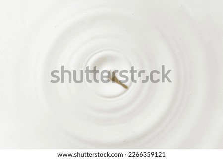 Milk circles ripple, splash waves from top view of water droplets background. dairy or yogurt swirl wheel textured surface template. Royalty-Free Stock Photo #2266359121