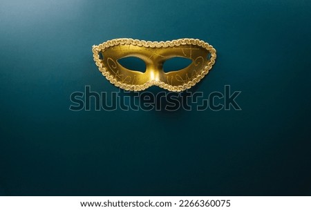 Happy Purim carnival decoration concept made from golden mask on dark background. (Happy Purim in Hebrew, jewish holiday celebrate)