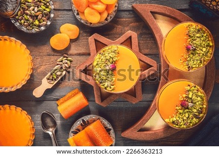 Arabic Cuisine; Dry Apricot Pudding (Qamar Al Deen). Middle Eastern delicious apricot pudding topped with crushed pistachio. It is one of the most famous Ramadan dessert recipes.  Royalty-Free Stock Photo #2266363213