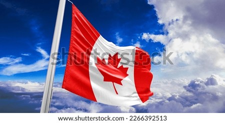 Canada national flag cloth fabric waving on beautiful blue sky.