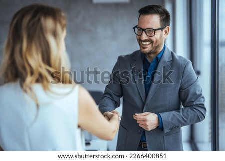 Shot of two businesspeople shaking hands in an office. Smiling business people handshake after successful negotiation. Handshake for the new agreement. Royalty-Free Stock Photo #2266400851