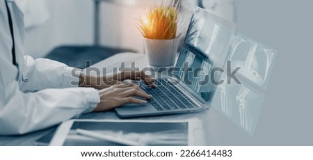 Medicine doctor hand touching on a patients x-ray scans digital healthcare and connection with modern virtual screen interface icons, Medical technology and network concept. Royalty-Free Stock Photo #2266414483